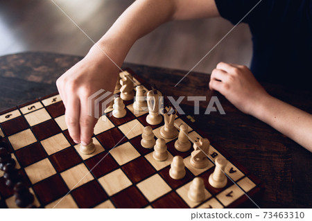 A boy plays chess at home during quarantine. Leisure, Hobbies. 73463310
