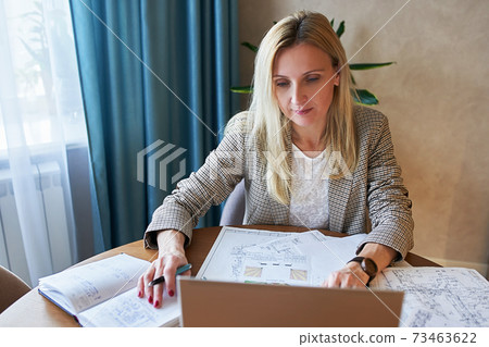 a woman at home sits at a computer a woman at home sits at a computer 73463622