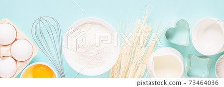 Ingredients for baking on light blue background. Ingredients for baking on light blue background. 73464036