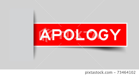 Inserted red color label sticker with word apology on gray background 73464102