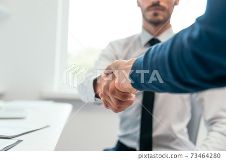 close up. financial partners are shaking hands with each other. close up. financial partners are shaking hands with each other. 73464280