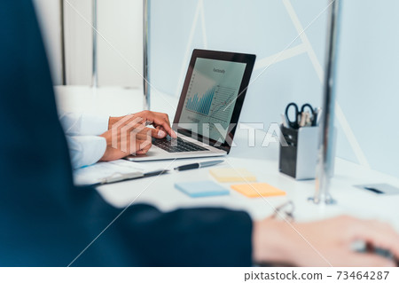 businessman works using a laptop to analyze financial data . businessman works using a laptop to analyze financial data . 73464287