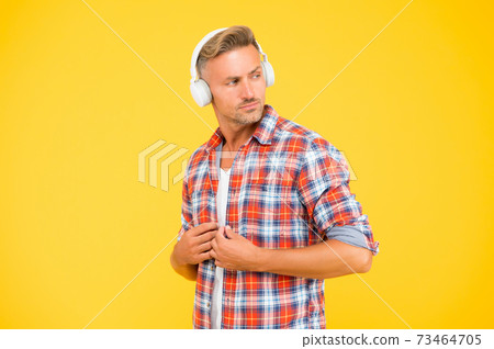 Handsome man button casual shirt listening to music Handsome man button casual shirt listening to music 73464705