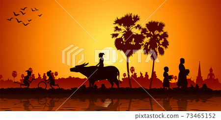 country life of Asia children play banana horse ride buffalo while monk receive food on sunrise time 73465152