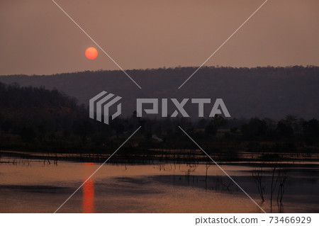 The sun is rising in the morning over the mountains in Thailand. The sun is rising in the morning over the mountains in Thailand. 73466929