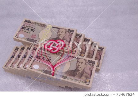 A wad of bills piled up in a staircase and a cute Mizuhiki heart 73467624