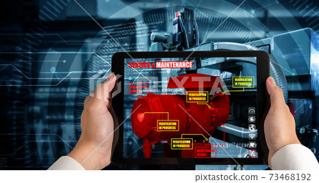 Engineer use augmented reality software in smart factory production line 73468192