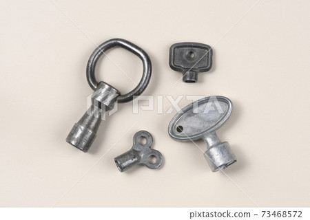 Panel key. Zinc Die Cast. Isolated on light background. Panel key. Zinc Die Cast. Isolated on light background. 73468572
