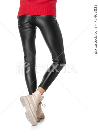 Shapely female legs in black leggings and boots isolated on white background. Shapely female legs in black leggings and boots isolated on white background. 73468832