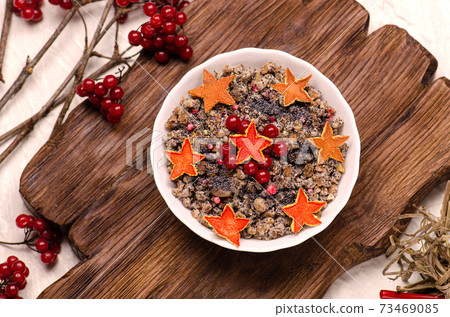 Pearl barley in bowl on a wooden table 73469085