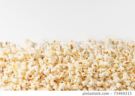 Delicious popcorn on white background. 73469315
