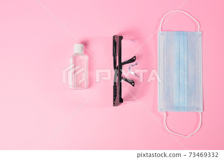 Hand sanitization, black medical glasses and protective mask. Hand sanitization, black medical glasses and protective mask. 73469332