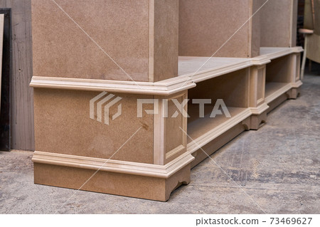 Joinery. Mdf cabinet carcass. Home library with classic design. Wooden furniture manufacturing process Joinery. Mdf cabinet carcass. Home library with classic design. Wooden furniture manufacturing process 73469627