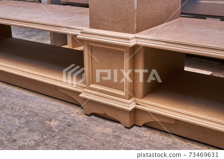 Joinery. Mdf cabinet carcass. Home library with classic design. Wooden furniture manufacturing process Joinery. Mdf cabinet carcass. Home library with classic design. Wooden furniture manufacturing process 73469631