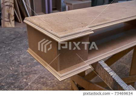 Joinery. Mdf cabinet carcass. Home library with classic design. Wooden furniture manufacturing process Joinery. Mdf cabinet carcass. Home library with classic design. Wooden furniture manufacturing process 73469634