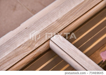 Joinery. Wooden cabinet doors. Wooden frame. Home library with classic design. Wooden furniture manufacturing process Joinery. Wooden cabinet doors. Wooden frame. Home library with classic design. Wooden furniture manufacturing process 73469645