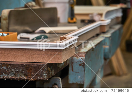 Joinery. Crown molding. Home library with classic design. Wooden furniture manufacturing process Joinery. Crown molding. Home library with classic design. Wooden furniture manufacturing process 73469646