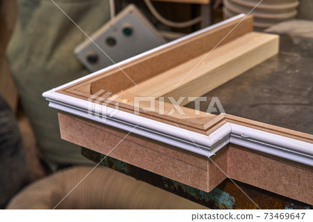 Joinery. Crown molding. Home library with classic design. Wooden furniture manufacturing process Joinery. Crown molding. Home library with classic design. Wooden furniture manufacturing process 73469647