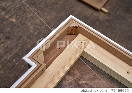 Joinery. Crown molding. Home library with classic design. Wooden furniture manufacturing process Joinery. Crown molding. Home library with classic design. Wooden furniture manufacturing process 73469653