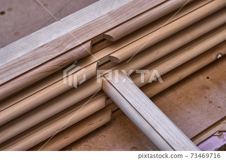 Joinery. Wooden cabinet doors. Wooden frame. Home library with classic design. Wooden furniture manufacturing process Joinery. Wooden cabinet doors. Wooden frame. Home library with classic design. Wooden furniture manufacturing process 73469716