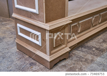 Joinery. Mdf cabinet carcass with moldings and decor. Wooden furniture manufacturing process Joinery. Mdf cabinet carcass with moldings and decor. Wooden furniture manufacturing process 73469753