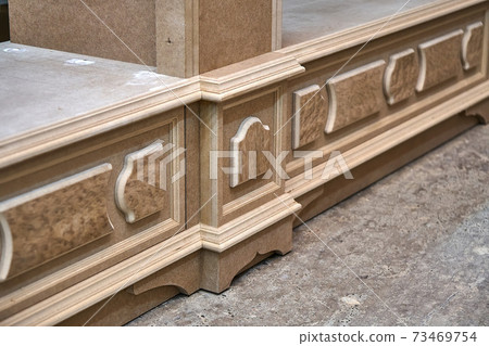 Joinery. Mdf cabinet carcass with moldings and decor. Wooden furniture manufacturing process Joinery. Mdf cabinet carcass with moldings and decor. Wooden furniture manufacturing process 73469754