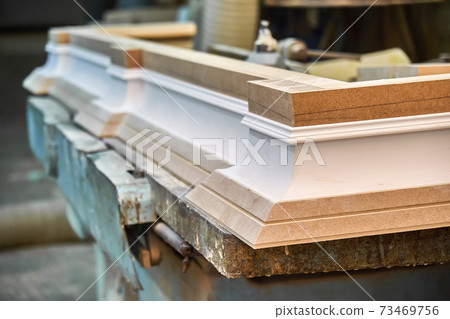 Joinery. Crown molding. Home library with classic design. Wooden furniture manufacturing process 73469756