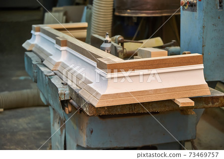 Joinery. Crown molding. Home library with classic design. Wooden furniture manufacturing process Joinery. Crown molding. Home library with classic design. Wooden furniture manufacturing process 73469757