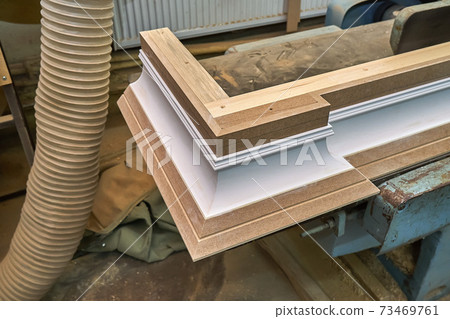 Joinery. Crown molding. Home library with classic design. Wooden furniture manufacturing process Joinery. Crown molding. Home library with classic design. Wooden furniture manufacturing process 73469761