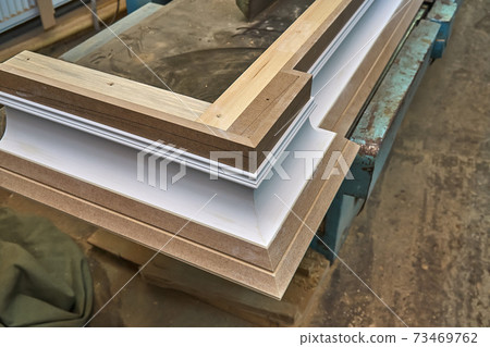 Joinery. Crown molding. Home library with classic design. Wooden furniture manufacturing process Joinery. Crown molding. Home library with classic design. Wooden furniture manufacturing process 73469762