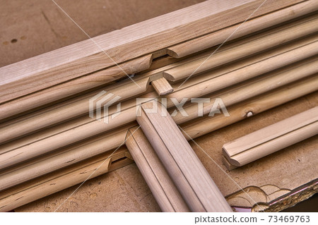 Joinery. Wooden cabinet doors. Wooden frame. Home library with classic design. Wooden furniture manufacturing process Joinery. Wooden cabinet doors. Wooden frame. Home library with classic design. Wooden furniture manufacturing process 73469763