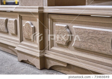 Joinery. Mdf cabinet carcass with moldings and decor. Wooden furniture manufacturing process Joinery. Mdf cabinet carcass with moldings and decor. Wooden furniture manufacturing process 73469849