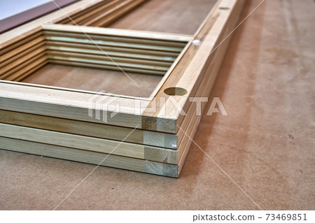 Joinery. Wooden cabinet doors. Wooden frame. Home library with classic design. Wooden furniture manufacturing process Joinery. Wooden cabinet doors. Wooden frame. Home library with classic design. Wooden furniture manufacturing process 73469851