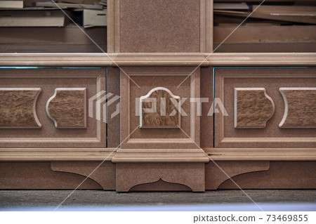 Joinery. Mdf cabinet carcass with moldings and decor. Wooden furniture manufacturing process Joinery. Mdf cabinet carcass with moldings and decor. Wooden furniture manufacturing process 73469855