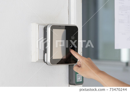 Finger print scan, Male employees press sensors to record company attendance time and after work, Time Recorder Attendance - Out work, Encryption for identity verification or electronic signing 73470244