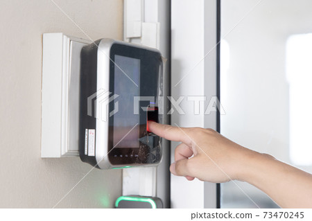 Finger print scan, Male employees press sensors to record company attendance time and after work, Time Recorder Attendance - Out work, Encryption for identity verification or electronic signing 73470245