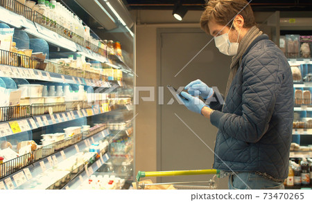 Handsome man with smartphone in the store Handsome man with smartphone in the store 73470265