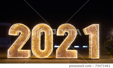 blurred background. defocused numbers 2021 on dark background blurred background. defocused numbers 2021 on dark background 73471461