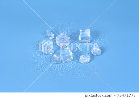 Ice cubes and chunks melting on a blue background 73471775