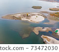 Scenic aerial drone birds eye view of swallow sand river or lake shore due to drought and water pond reservoir dam draining. Natural disaster of arid, warmand dry climate change 73472030