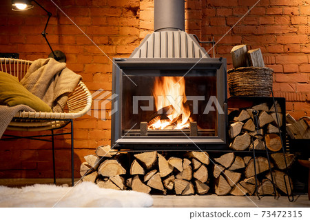 Burning fireplace with firewood at home 73472315