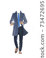 businessman in a coat with a cup of coffee 73472695