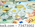 Various cryptocurrency coins on paper dollar and euro banknotes. Bitcoin, ethereum, litecoin and others modern virtual currency 73473002
