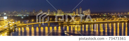Kyiv (Kiev) city, the capital of Ukraine at night beside the Dnipro (Dniepr) river with reflection in water 73473361