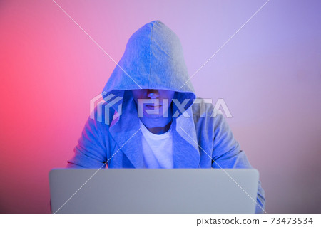 Gamer plays on a laptop. The programmer writes the code. Man on a colored background 73473534