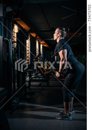 young athlete has physical workout with barbell in modern gym young athlete has physical workout with barbell in modern gym 73473705