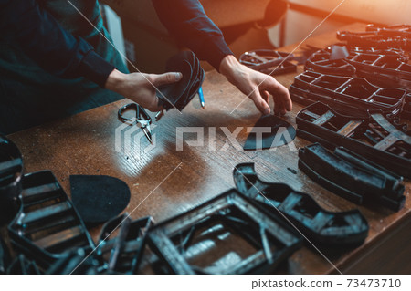 people working with press machinery for cutting shoe leather people working with press machinery for cutting shoe leather 73473710