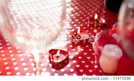 Candles for valentines day, table with festive red background Candles for valentines day, table with festive red background 73473896
