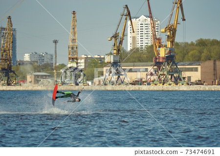 Young man riding wakeboard on a summer lake 73474691