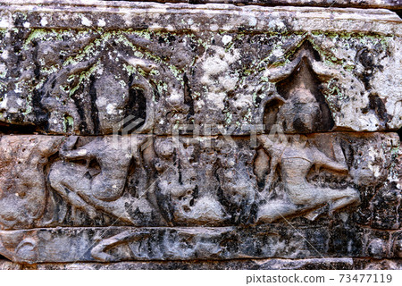 Stone carvings on the walls of the Bayon Temple in Angkor Thom 73477119